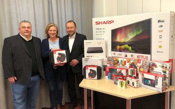 v.r. Gert Vorwalder, Geschäftsführer komro GmbH und Holger Jarrath von JARRATH.COM übergeben die Multimedia-Weihnachtsgeschenke an Heimleiterin Wilhelmine Hansen (mitte)